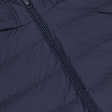 Close-up of the MONCLER Vermeille Hooded Puffer Jacket in navy blue, showing horizontal quilting and a black central zipper.
