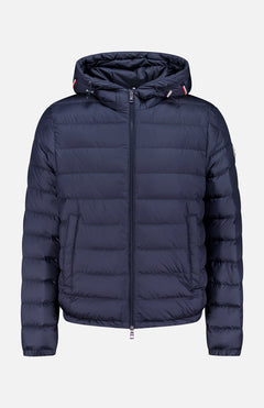 The MONCLER Vermeille Hooded Puffer Jacket, in navy blue with quilting, front zipper, hood, and two side pockets, is stylishly displayed on a plain light gray background.