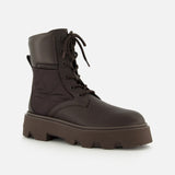 The MONCLER Aurea Quilted Ankle Boots feature a dark brown lace-up design with a thick, rugged sole and stitching details, shown against a plain light background.