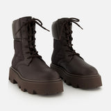 Pair of dark brown Aurea Quilted Ankle Boots by MONCLER, crafted from leather and nylon with a utility-inspired design, lace-up fronts, and thick chunky soles on a plain white background.