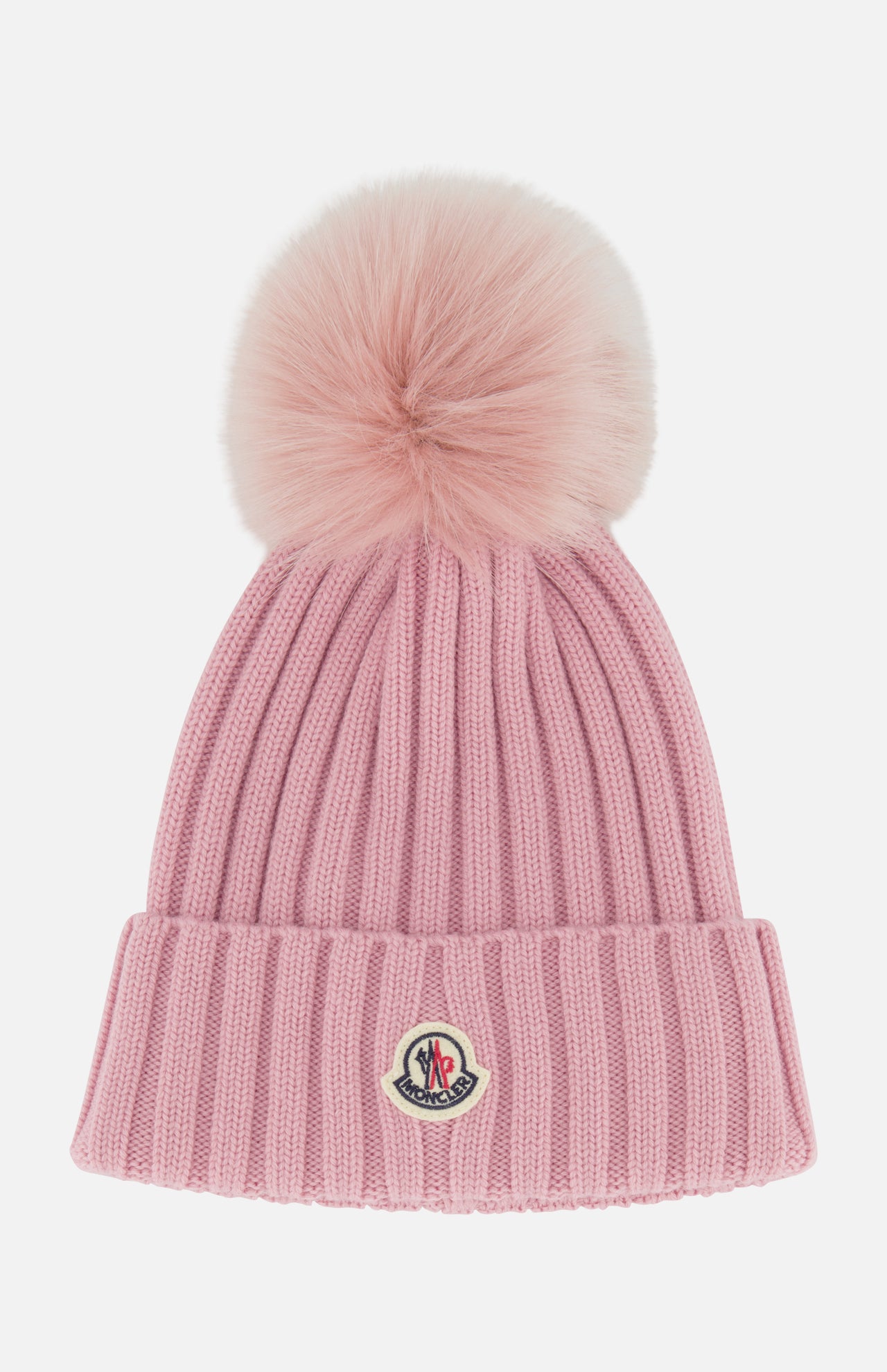 Introducing the MONCLER Ribbed Pom Beanie—crafted in pink ribbed knit with a large, fluffy faux fur pom pom on top and a folded brim accented by a small embroidered logo patch at the front.