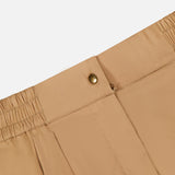 Close-up of the MONCLER Brushed Techno Cotton Shorts’ waistband, showing an elasticized back, gold button closure, and side pockets, inspired by high-performance outerwear, set against a plain white background.