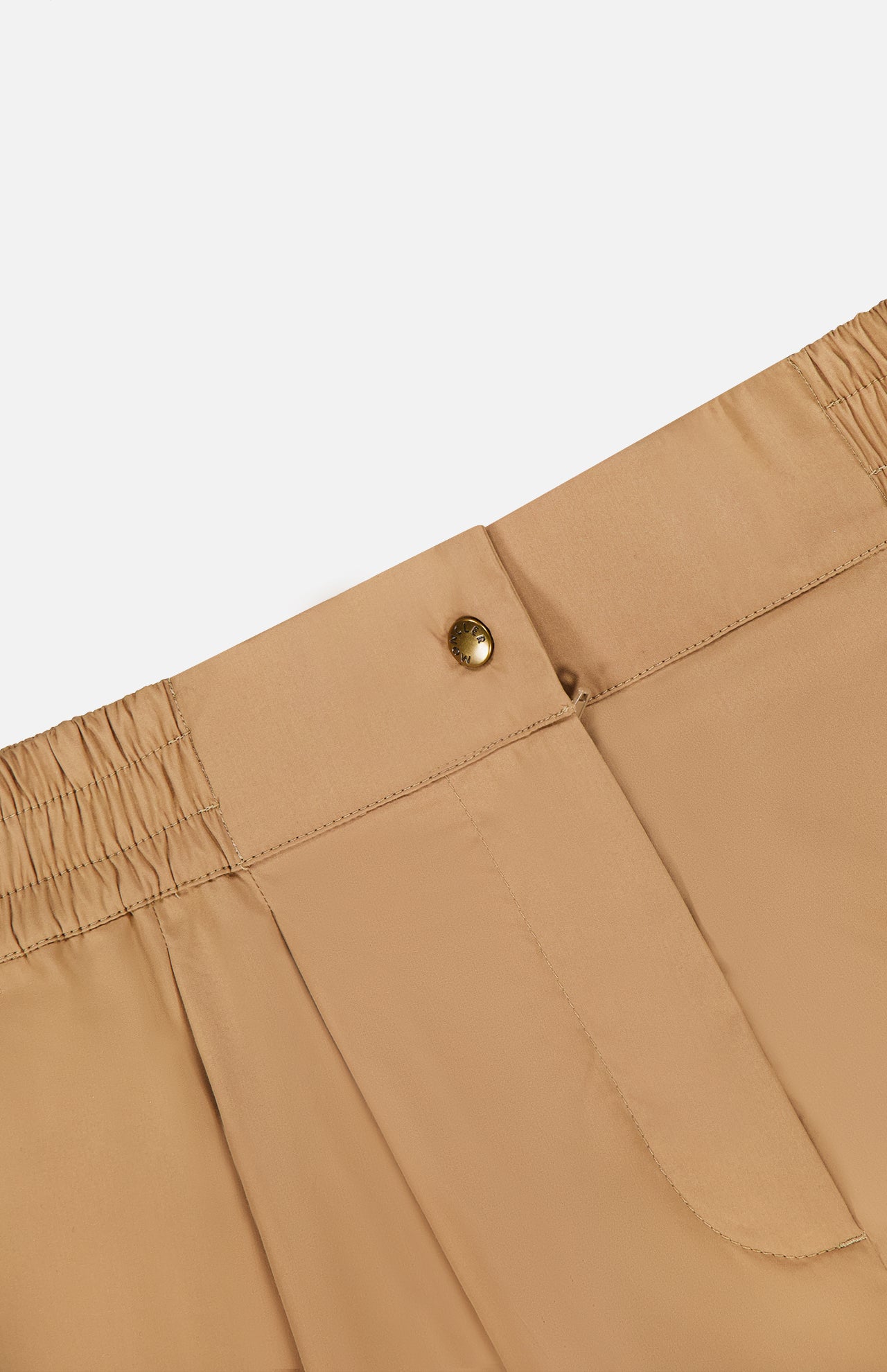 Close-up of the MONCLER Brushed Techno Cotton Shorts’ waistband, showing an elasticized back, gold button closure, and side pockets, inspired by high-performance outerwear, set against a plain white background.