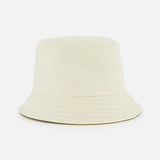 The MONCLER Reversible Bucket Hat, shown against a white background, features a plain light beige design with visible stitching and a wide, downward-sloping brim.