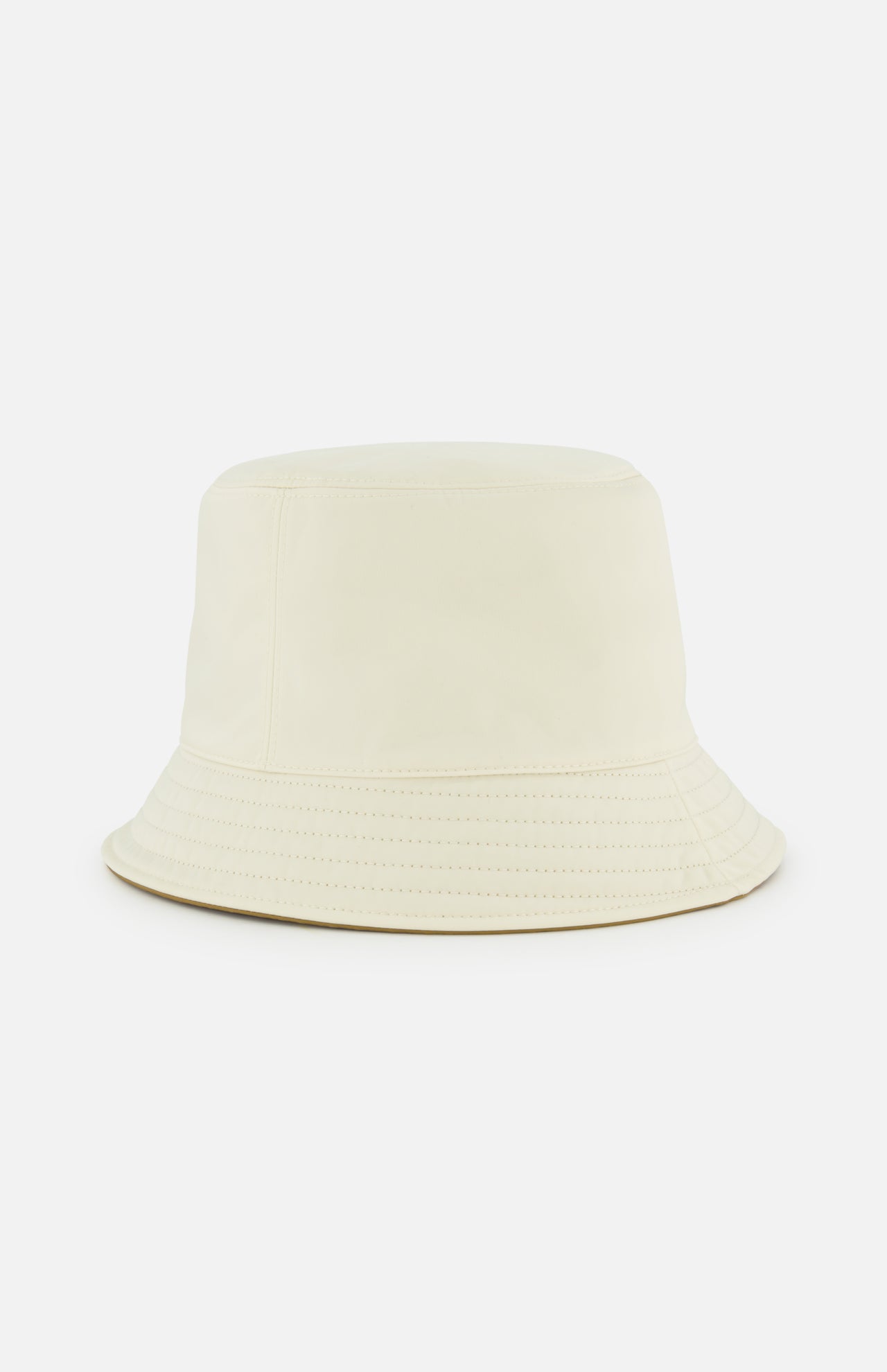 The MONCLER Reversible Bucket Hat, shown against a white background, features a plain light beige design with visible stitching and a wide, downward-sloping brim.