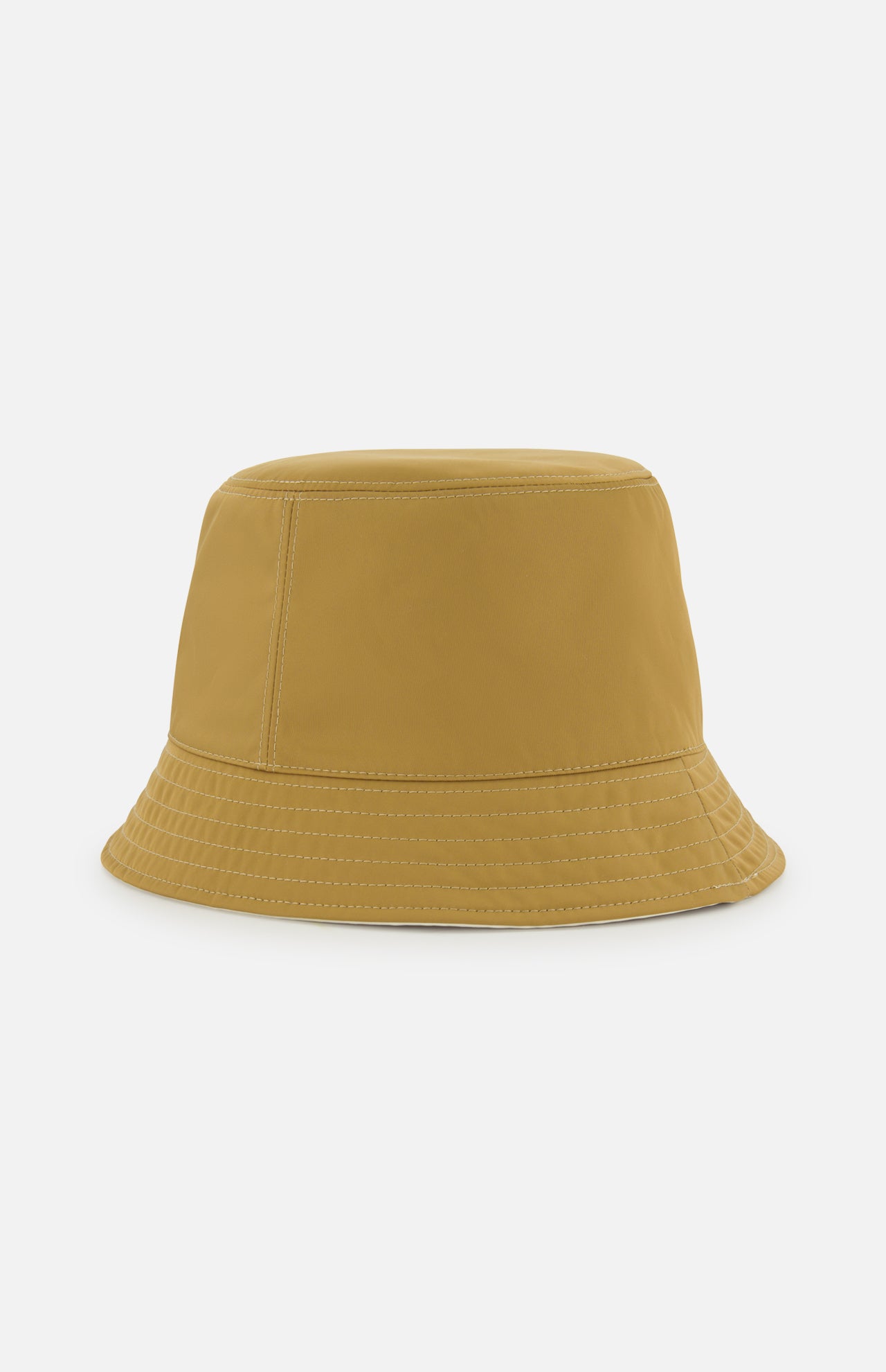 A reversible MONCLER bucket hat in plain mustard yellow, featuring visible stitching on the brim and crown, shown on a white background.