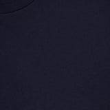 A close-up image of the MONCLER Embroidered Hem Mini Dress, radiating summer sophistication, with a small white Moncler brand tag visible at the collar.