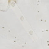 Close-up of the MONCLER Embroidered Mini Dress, showcasing a large collar, decorative floral embroidery, and embossed white buttons.