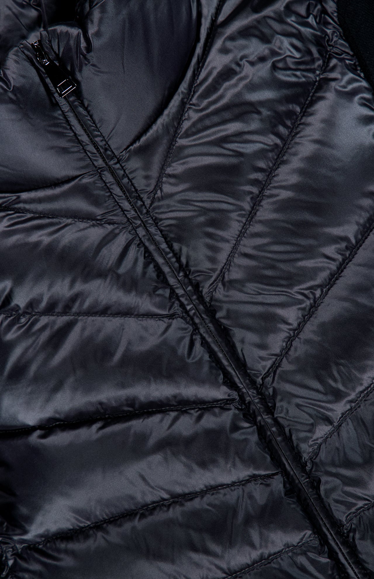 Close-up view of the MONCLER Extrafine Wool Cardigan, showcasing its sleek, quilted design with stitched horizontal lines and a visible diagonal zipper.