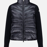 Crafted by MONCLER, the Extrafine Wool Cardigan features a high collar and full front zipper, with quilted panels on the front and back and solid black sleeves. This padded black cardigan blends exceptional warmth with contemporary style.