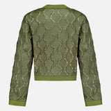 The MONCLER Libellule Water Repellent Quilted Jacket features a feminine olive green design with a geometric quilted pattern, long sleeves, and solid green trim at the cuffs, hem, and neckline, displayed from the back against a light background.