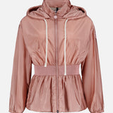 The MONCLER Liriope Hooded Rain Jacket in light pink features a shiny finish, front zipper, white drawstrings, smocked elastic waist, and long sleeves with elastic cuffs. Shown against a plain white background. High-performance outerwear at its finest.