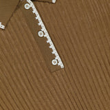 Close-up of the MONCLER Long Sleeve Stitched Polo, crafted in ribbed brown fabric with a collar and white crochet trim on the placket, three white buttons, and the MONCLER label visible inside the collar.