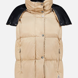 The Macareux Down Puffer Vest by MONCLER features a beige design with silver buttons, zipper pockets, a high collar, and black shoulder detailing, all set against a plain white background. Engineered for lightweight warmth and water-repellency, this vest seamlessly blends style with functionality.