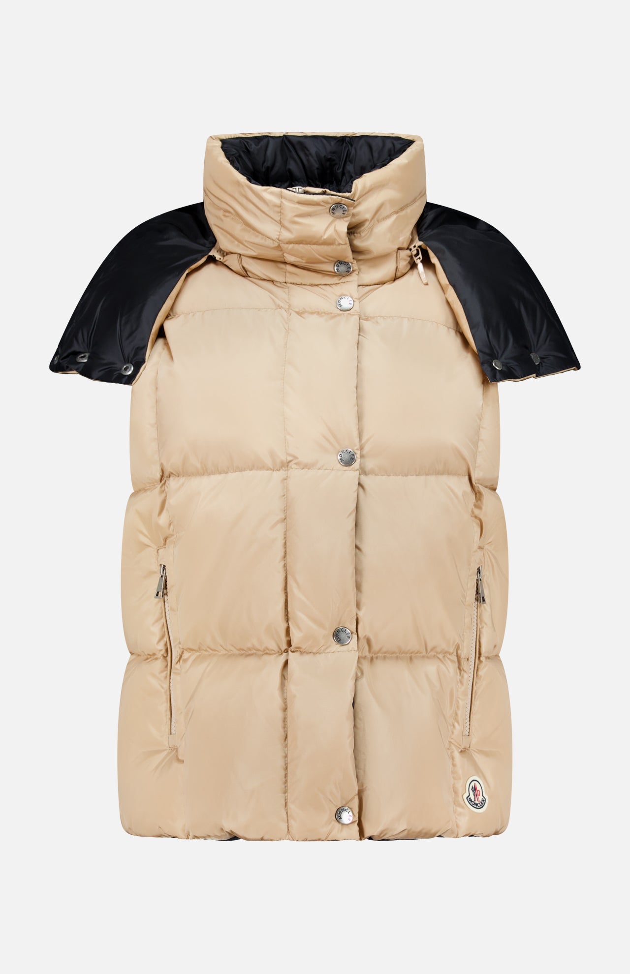 The Macareux Down Puffer Vest by MONCLER features a beige design with silver buttons, zipper pockets, a high collar, and black shoulder detailing, all set against a plain white background. Engineered for lightweight warmth and water-repellency, this vest seamlessly blends style with functionality.