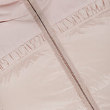 Close-up of the MONCLER Meditation Puffer Jacket in light pink, down-filled with a visible zipper and gathered stitching detail beneath the collar.