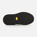 Black Moncler Altive Mid Snow Boots sole with a thick tread pattern and a small yellow logo insert.