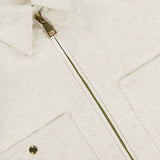 Close-up of the MONCLER Bouclé Fabric Shacket Shirt in cream cotton-blend, featuring textured bouclé, a metal zipper, collared neckline, two front pockets (one with a snap button), and the brand label inside the collar.