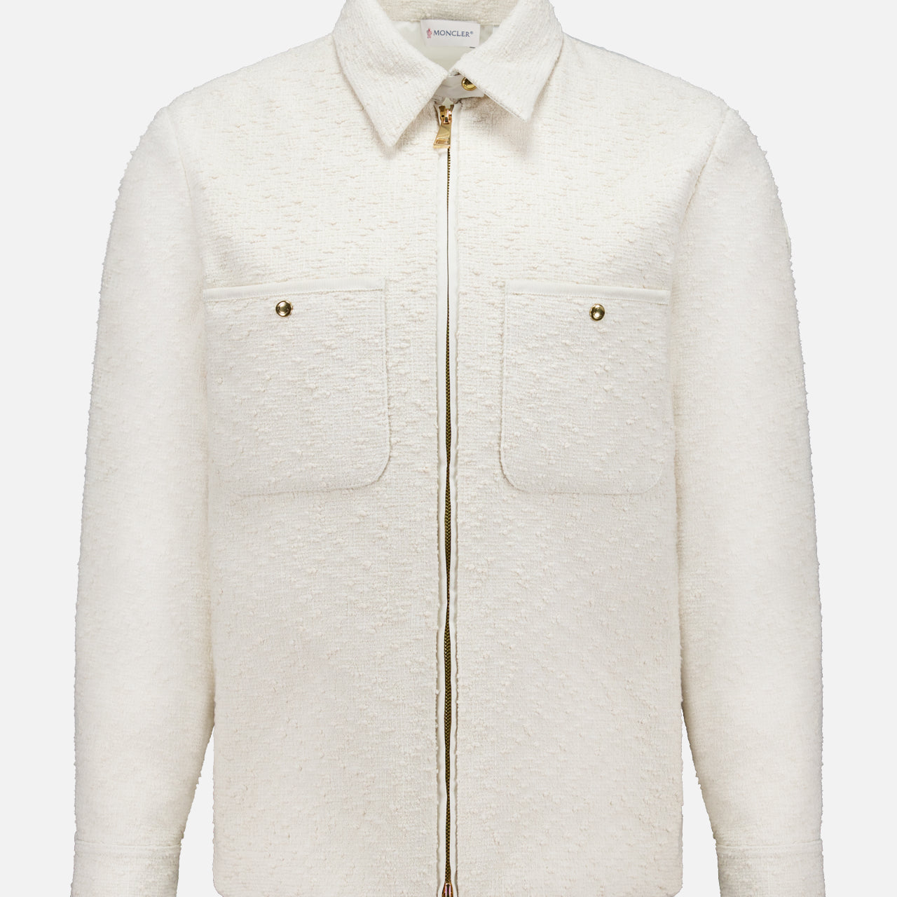 The MONCLER Bouclé Fabric Shacket Shirt in cream features long sleeves, textured cotton-blend bouclé, a classic collar, front zipper closure, and two button-flap chest pockets, shown against a plain white background.