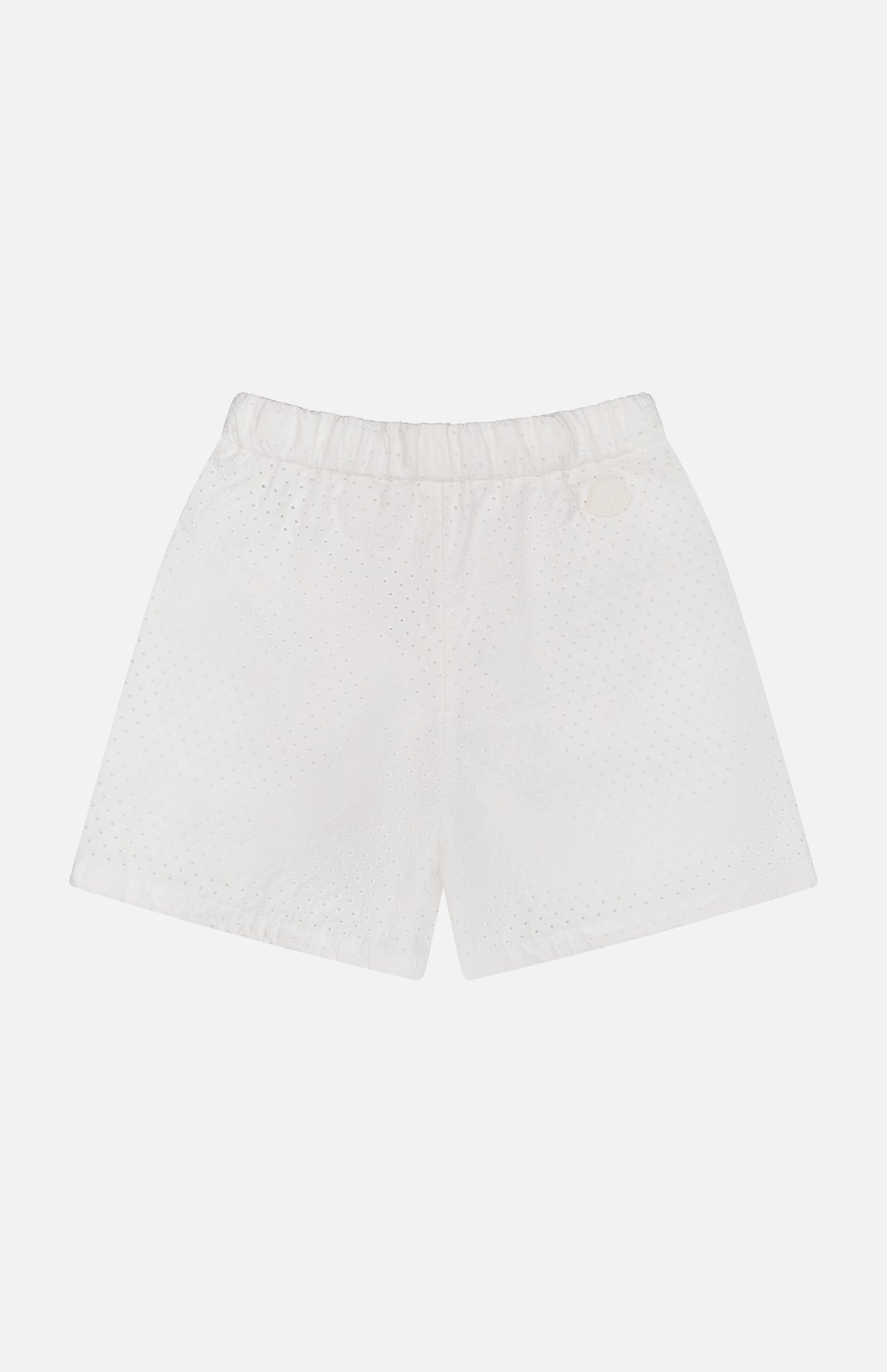 MONCLER Drawstring Eyelet Shorts in white, knee-length with an elastic waistband and subtle dotted texture, shown against a plain white background.