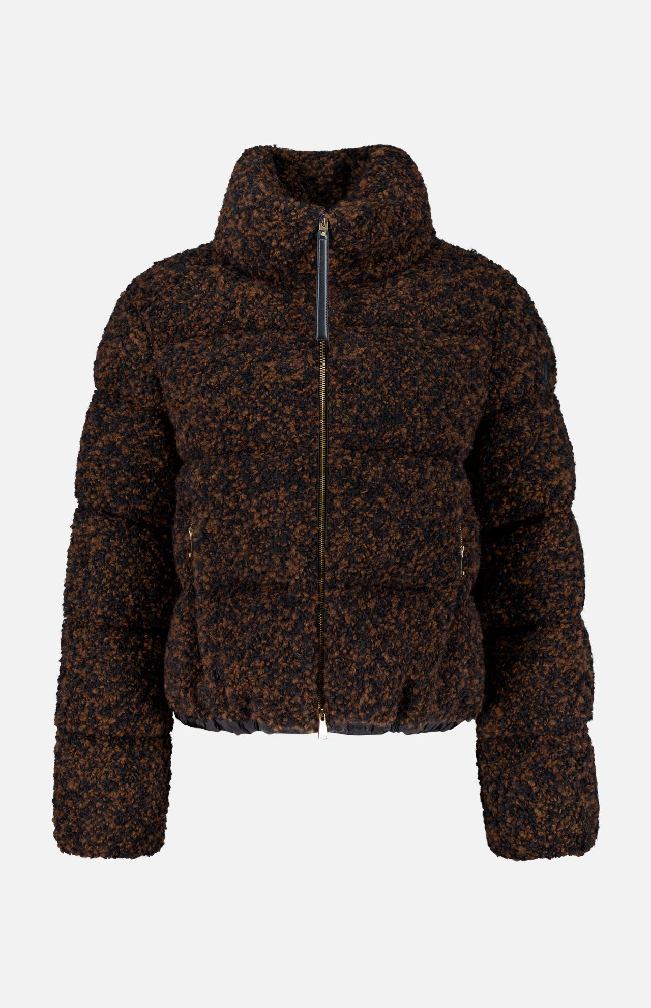 The MONCLER Trascendance Tweed Jacket is an elegant women’s outerwear piece, featuring a brown and black textured design with a high collar, front zipper, and long sleeves. Combining the warmth of a classic MONCLER down jacket with the sophisticated appeal of tweed, this jacket is displayed against a plain white background.