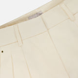 Close-up of the waistband and upper section of MONCLER Wide Leg Trousers in cream, featuring belt loops, a visible interior label, and a high-rise wide leg silhouette.