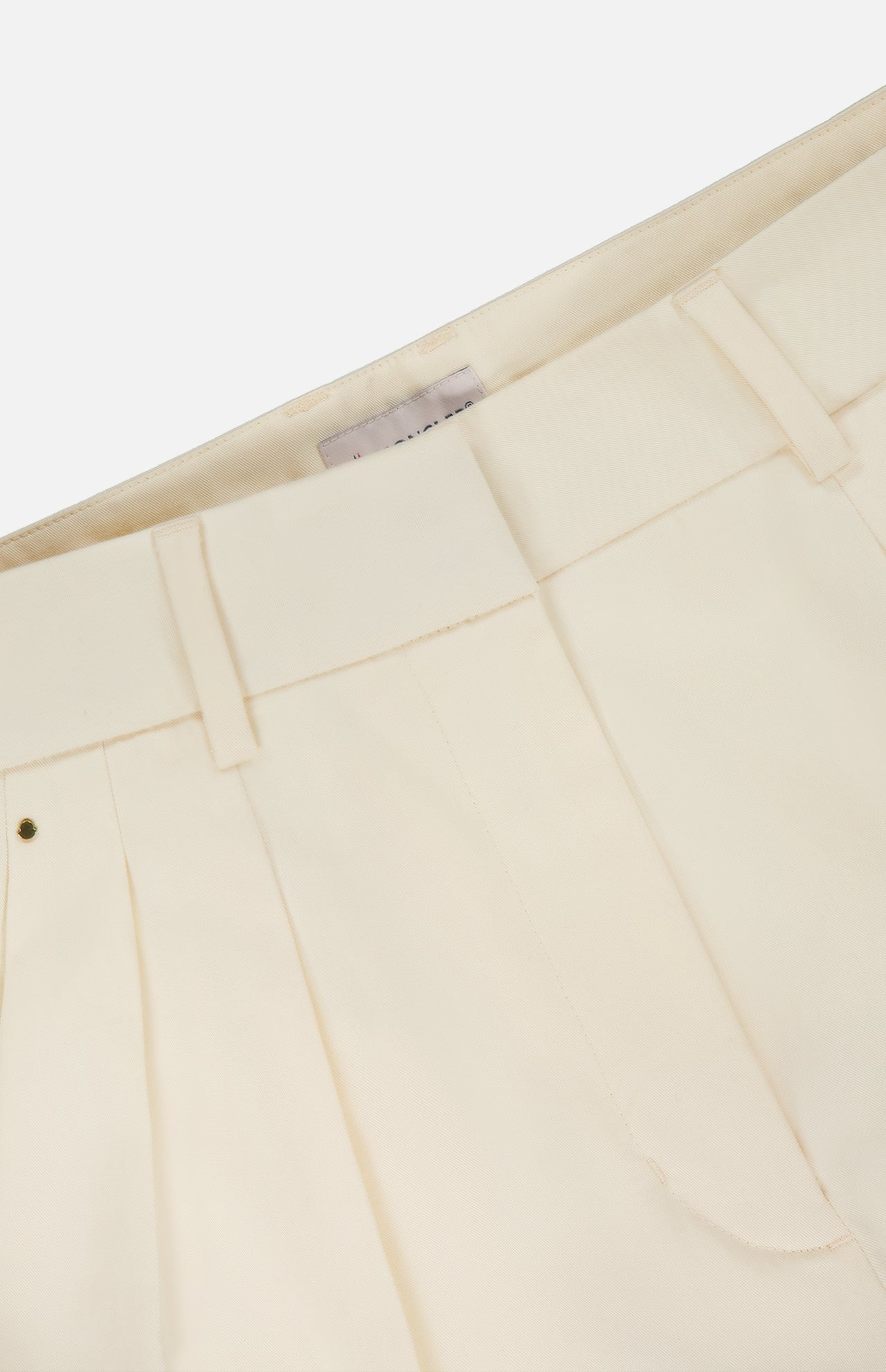 Close-up of the waistband and upper section of MONCLER Wide Leg Trousers in cream, featuring belt loops, a visible interior label, and a high-rise wide leg silhouette.