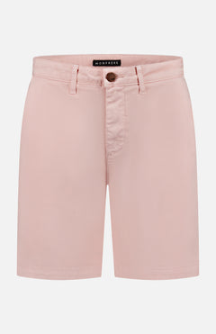 Light pink Cruise Tailored Shorts by MONFRERE featuring brushed twill fabric, belt loops, a button and zip closure, and side pockets, shown against a white background with the MONFRERE label inside the waistband.