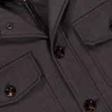 Close-up of the Dasson Removable bib Jacket by MOORER, made from brown virgin wool with large buttons, flap pockets, and a visible zipper on the inner lining. The thick fabric is ideal for cold weather.