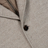 Close-up of the Monferrato Removable Bib Jacket by MOORER in light gray virgin wool, featuring a dark button, lapel, and a detachable light brown zippered interior bib.