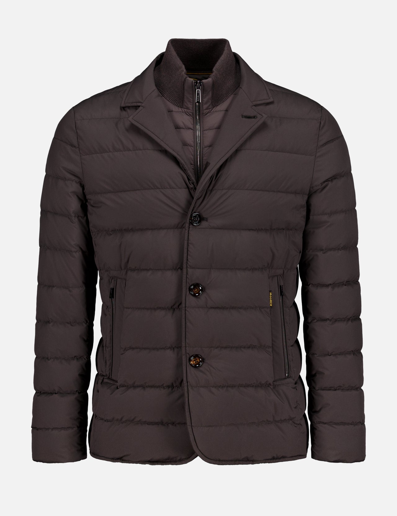 The Sinardi Removable Bib Jacket by MOORER is a dark brown blazer-style jacket with two front pockets, two buttons, a visible inner zipper layer, and a detachable puffer bib for added warmth and style.