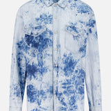 The Exes And Ohs Overshirt by MOTHER is a Western-inspired, long-sleeve button-up with two chest pockets and a light blue and white tie-dye floral print on crisp white.