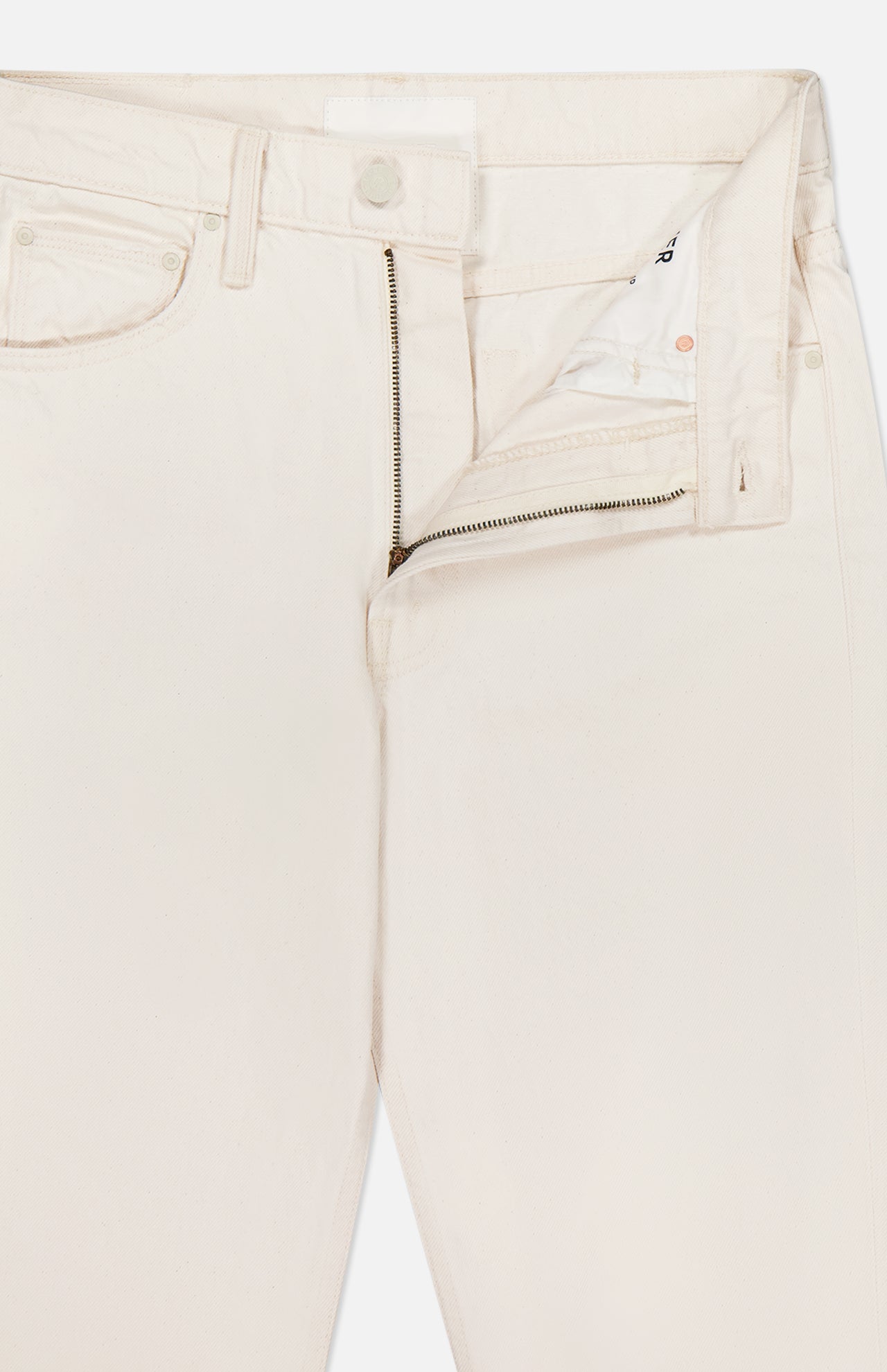 The Scooter Skimp Flare Leg Pant by MOTHER is a pair of off-white, high-rise jeans shown with the waistband unbuttoned and zipper partially open, revealing the inside pocket and fly area.