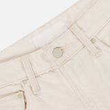 Close-up of the waistband and upper section of MOTHER's The Scooter Skimp Flare Leg Pant in cream, featuring a button, belt loops, front pocket, and a blank white label on the inside.