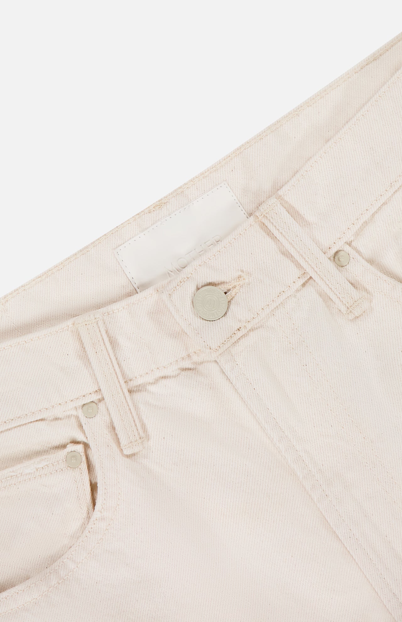 Close-up of the waistband and upper section of MOTHER's The Scooter Skimp Flare Leg Pant in cream, featuring a button, belt loops, front pocket, and a blank white label on the inside.