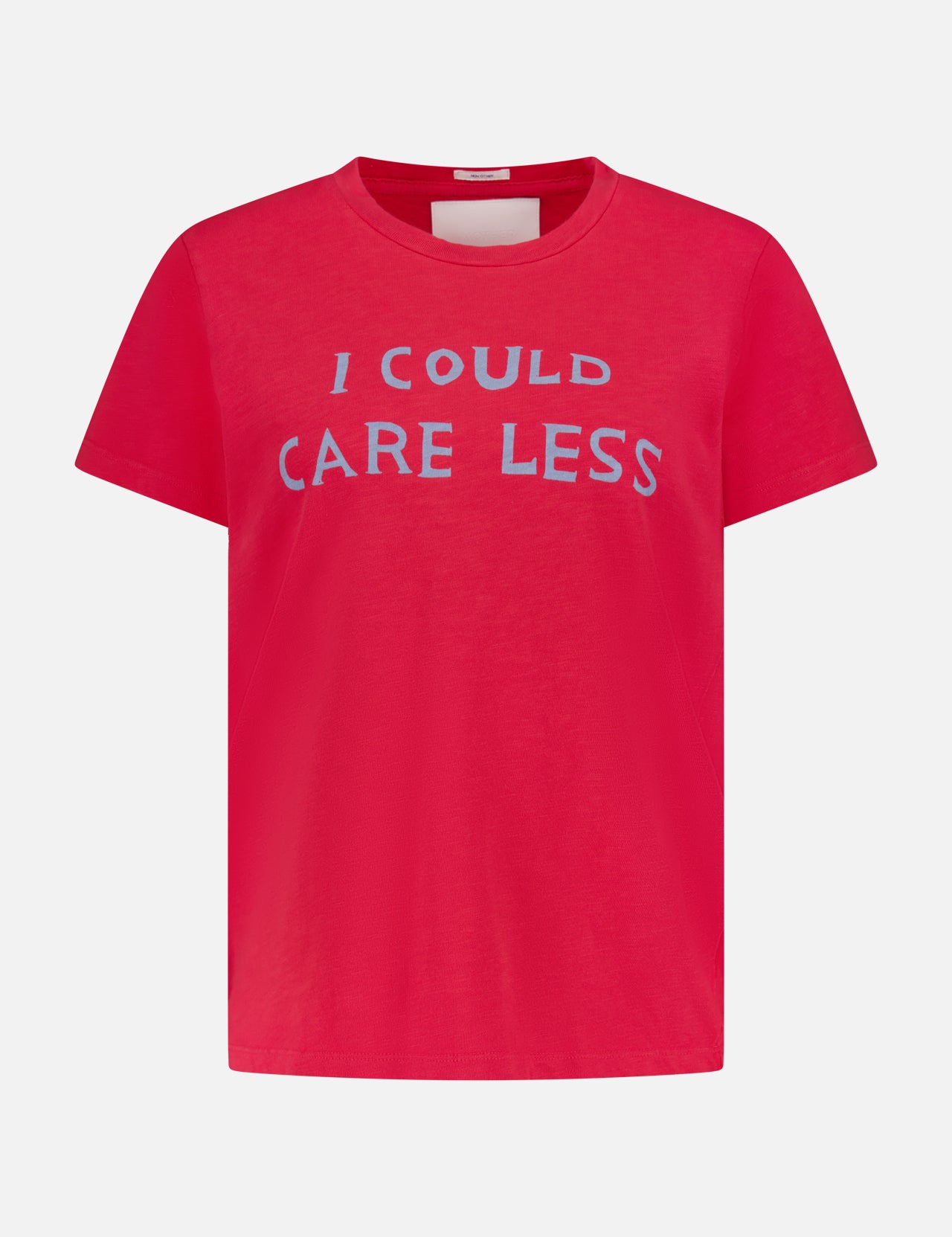 The Sinful Slim T-shirt by MOTHER is a bright pink vintage-style short-sleeve tee with "I COULD CARE LESS" in bold light blue letters on the chest, shown against a plain light gray background.