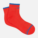 The MOTHER Baby Steps Ankle Socks are bright red with blue trim at the cuff and toe, visible ribbed texture, and blue lettering near the toe and cuff—perfect for making a bold statement.