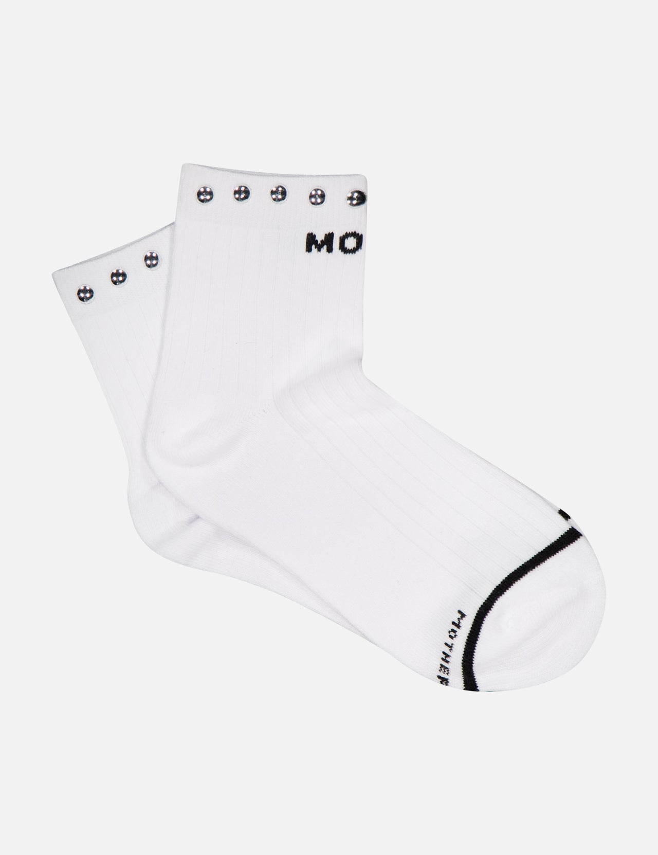 A pair of MOTHER Baby Steps Ankle Socks with Studs in a white cotton-blend, featuring black smiley face designs around the top edge and black text partially visible on the cuff and toe—perfect for making a subtle statement with your socks.