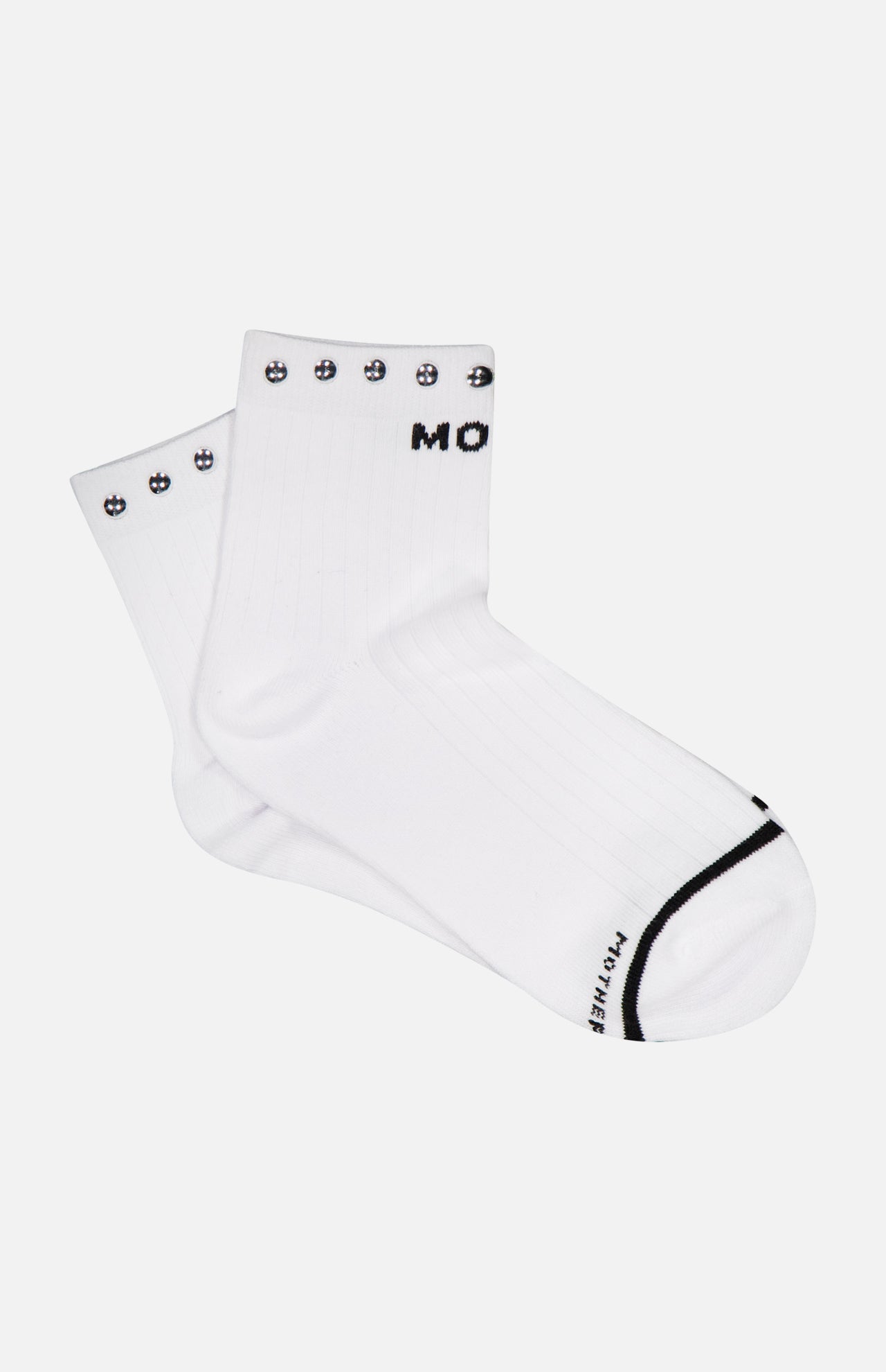 A pair of MOTHER Baby Steps Ankle Socks with Studs in a white cotton-blend, featuring black smiley face designs around the top edge and black text partially visible on the cuff and toe—perfect for making a subtle statement with your socks.