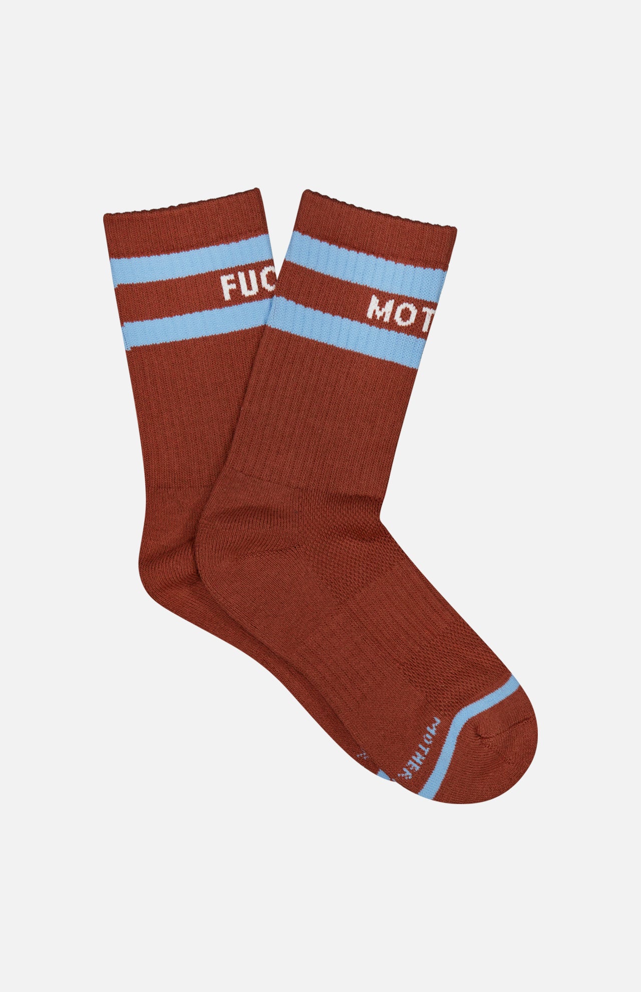 A pair of MOTHER Baby Steps Stripe Socks in brown with light blue stripes near the top. These unisex socks feature white text that partially reads “FUC” on one and “MOT” on the other.