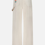 Back view of off-white wide-leg Bees Knees Stud Finder Cargo Pant in Act Natural by Mother, featuring a colorful graphic patch on the back pocket.