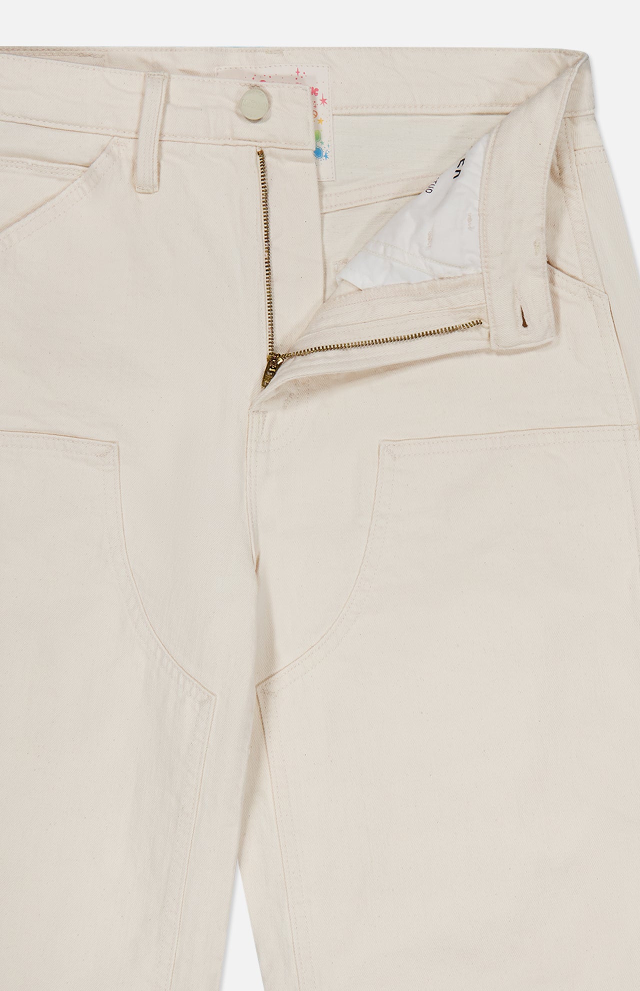 Close-up of cream-colored Mother Bees Knees Stud Finder Cargo Pant in Act Natural, featuring a zippered fly, button closure, and large front patch pockets.