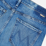 Close-up of the MOTHER Lilrunaway Jeans in On A Roll, highlighting the back waistband, belt loop, and a single back pocket with signature M-shaped stitching. These mid-rise jeans feature faded denim along the waistband and edges, showcasing their classic style.