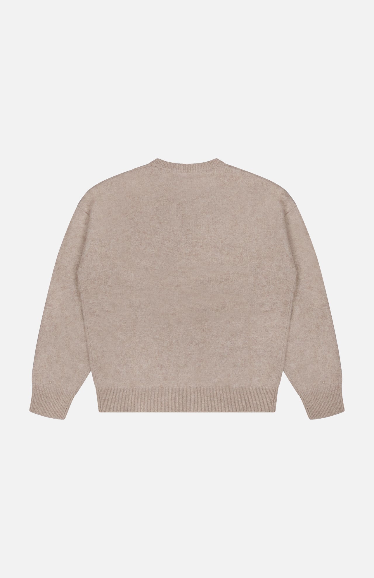 Back view of The Biggie Pegasus Jumper Sweater by MOTHER, shown in a plain, light beige shade and laid flat on a white background. This oversized crew neck sweater features ribbed cuffs, hem, and neckline, with no visible patterns or designs.