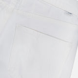 Close-up of the back pocket and waistband of MOTHER's The Bookie Skimp Pant in Picket Fence, featuring a small silver brand tag near the belt loop and subtle pocket stitching.