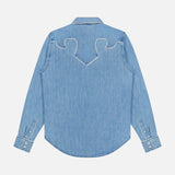 The Country Exe’s Shirt by MOTHER is shown from the back in light blue denim, featuring long sleeves and western-inspired white decorative stitching in a curved pattern across the shoulders.