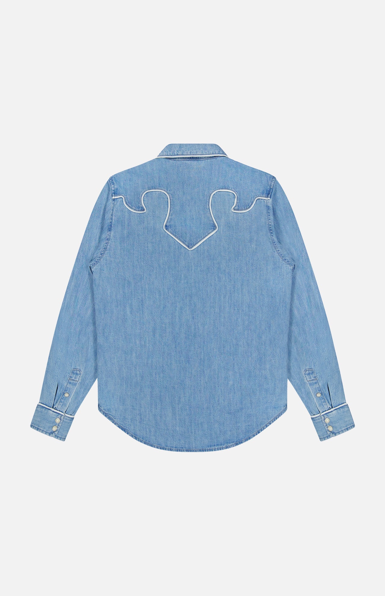 The Country Exe’s Shirt by MOTHER is shown from the back in light blue denim, featuring long sleeves and western-inspired white decorative stitching in a curved pattern across the shoulders.