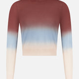 The MOTHER Crew Neck Ombre Jumper Sweatshirt features long sleeves and a gradient design, fading from dark reddish-brown at the top to light blue in the middle and cream on the bottom and sleeves.