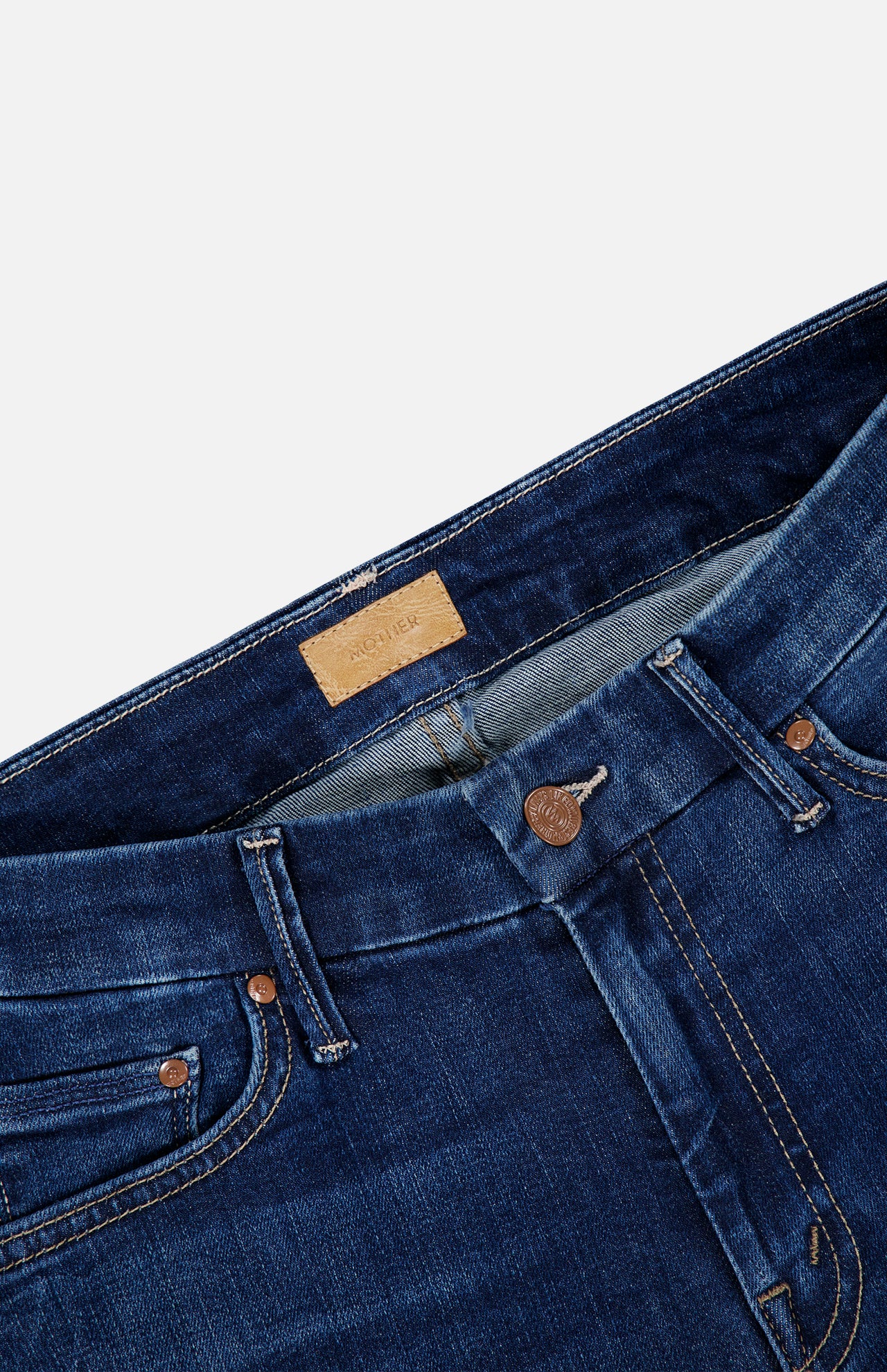 Close-up of the waistband, button fly, and leather label on dark blue stretch denim The Down Low Looker Hover Jeans in Backstage skinny jeans.