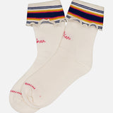 The Fold Please Socks by MOTHER are white ankle-length tube socks with ruffled tops, horizontal navy, yellow, red, and white stripes, and pink embroidered writing—perfect for adding a playful touch to any outfit.